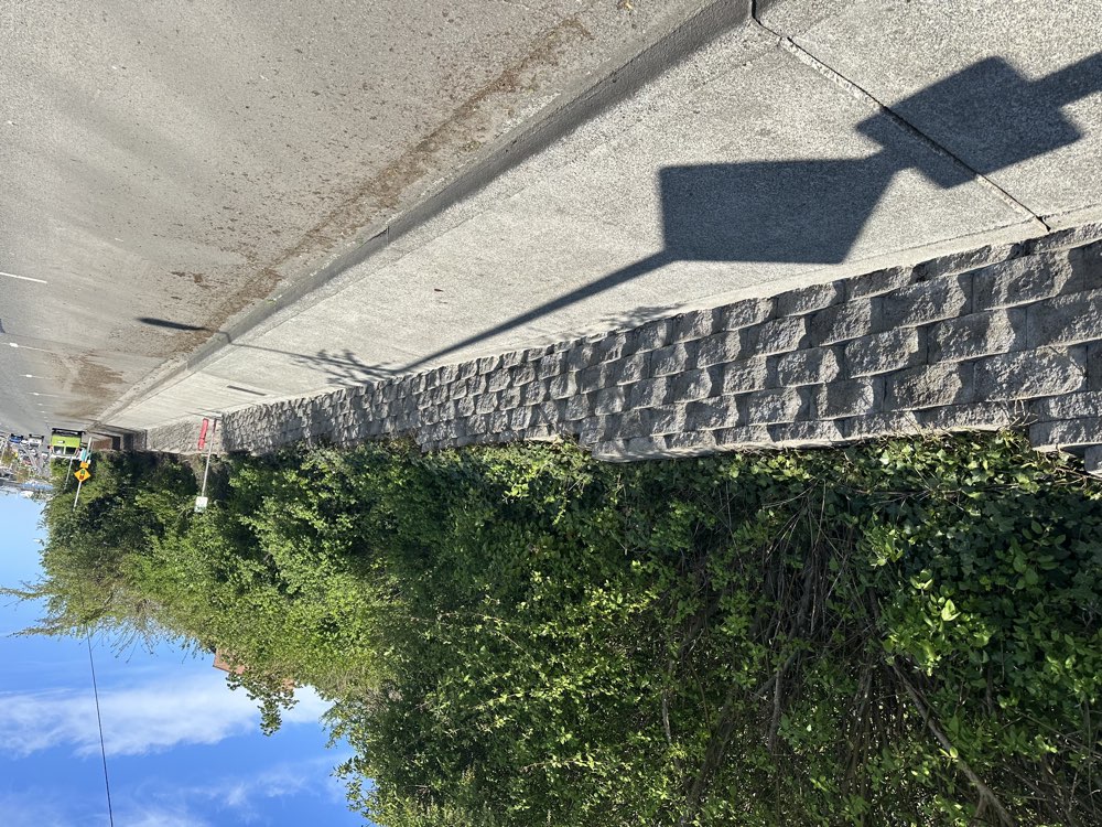 Downtown Port Angeles retaining wall after cleaning, restored to bare concrete block