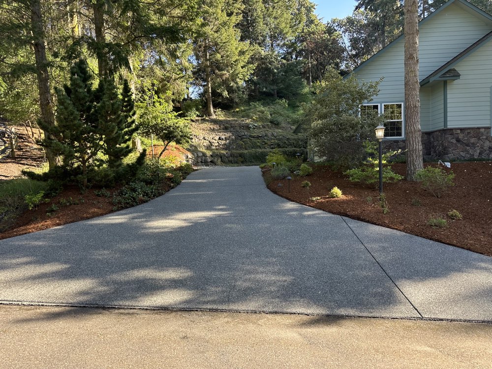 Curved exposed-aggregate driveway in Sequim, WA after pressure washing